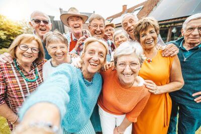 Senior citizens smiling and taking a selfie